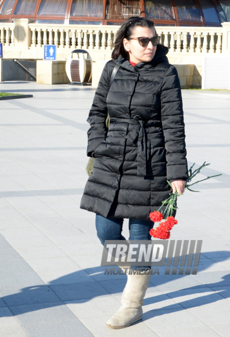 Baku residents bringing flowers to Seaside Boulevard to honor missing oil workers.  Azerbaijan, Dec.07, 2015